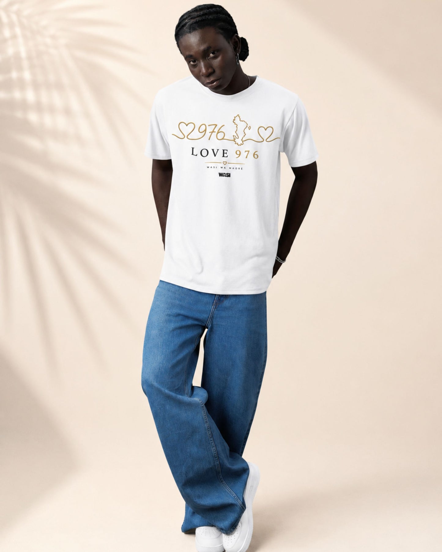 Personne portant un t-shirt blanc WASI LOVE 976 en 100 % coton, vêtement streetwear unisexe inspiré de Mayotte avec design cœur, carte de Mayotte et numéro 976, en studio lifestyle.