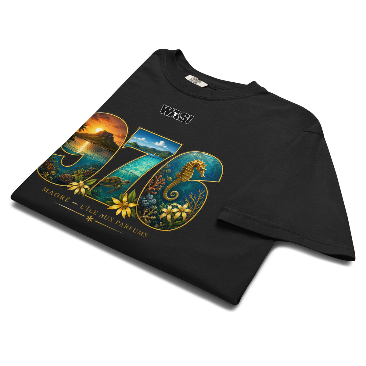 T-shirt noir WASI plié présentant le design « 976 Lagon Maoré » inspiré du lagon de Mayotte, avec un hippocampe, des fleurs tropicales et un paysage maritime.
